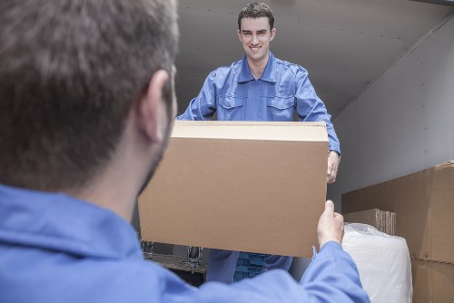 Removal team handling boxes safely in Kennington