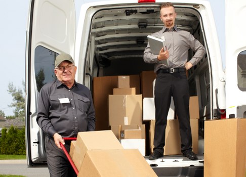Business relocation team handling office furniture during a move in Kennington