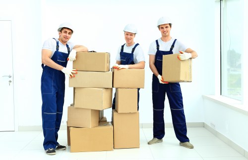 Removal team handling moving boxes safely