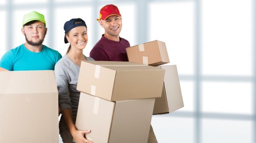 Packed household boxes and furniture ready for transport in Kennington
