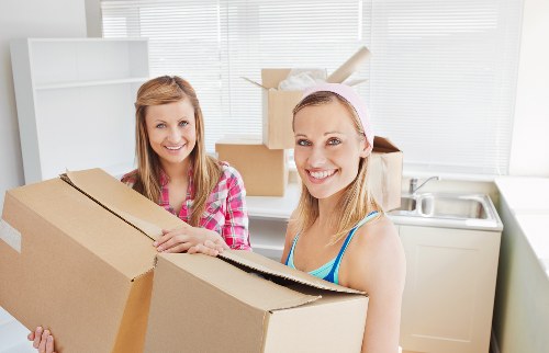Local movers handling furniture in a Kennington flat